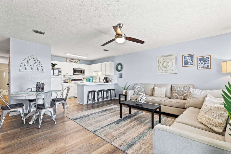Spacious living room with 2 comfy couches. Enjoy the ceiling fan, smart TV