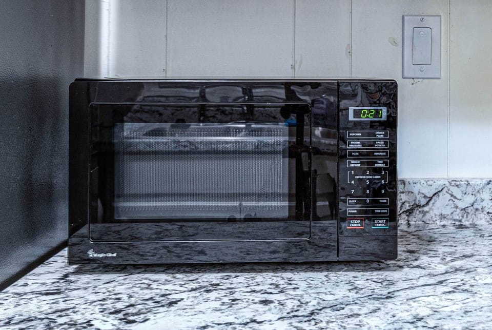 Kitchen with Gleaming Stainless Steel Appliances and Microwave