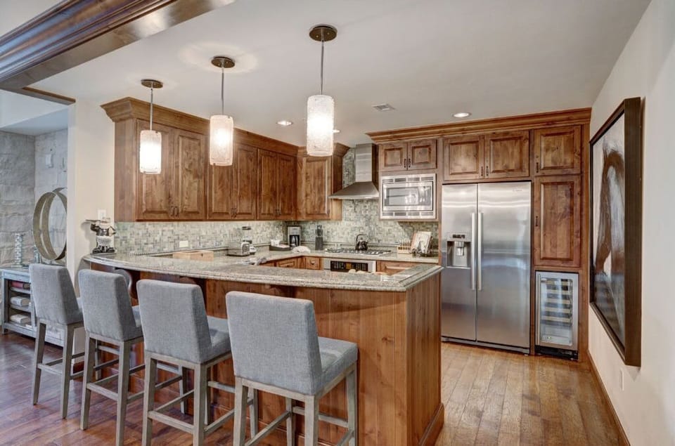 Gourmet kitchen with a spacious island and modern lighting.