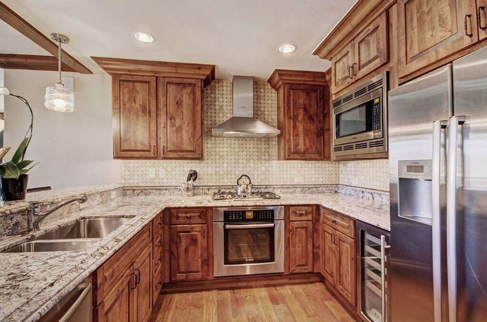 Modern kitchen with granite countertops and high-end appliances.