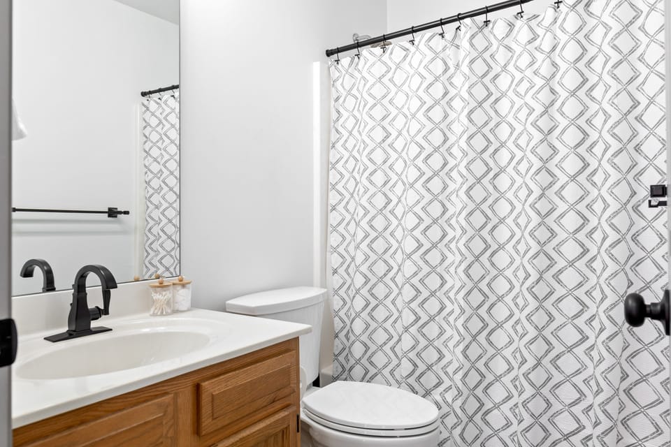 The second full bath provides a vanity, toilet, and tub-and-shower combination.