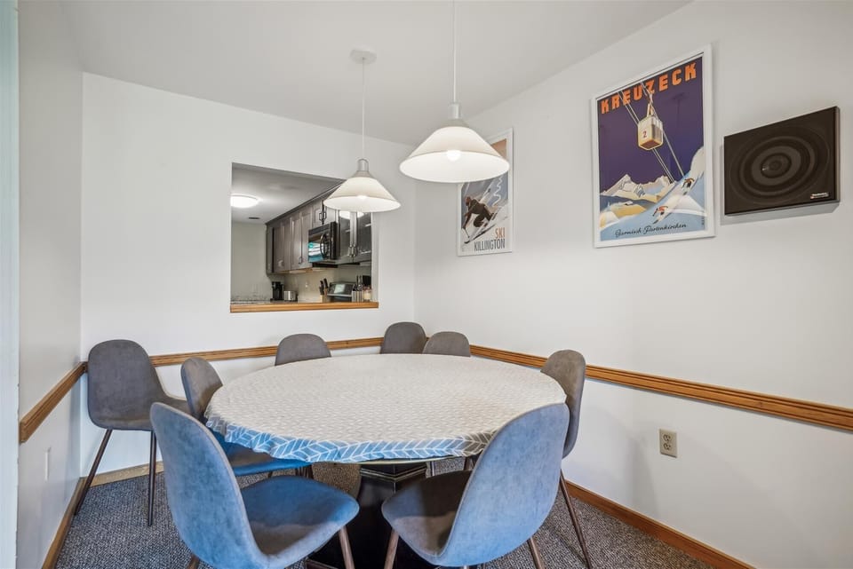 Bright dining nook accented with classic alpine artwork and easy access to the kitchen.