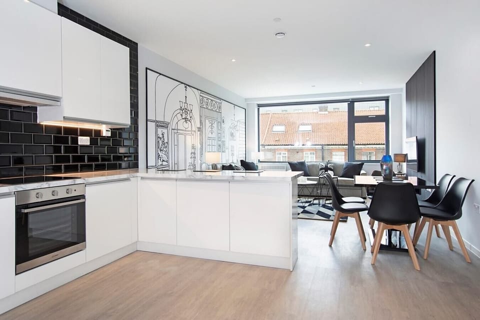 Integrated living, bedroom, and kitchen spaces in an open layout.