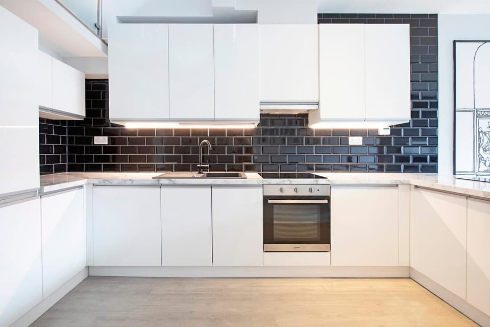Integrated living, bedroom, and kitchen spaces in an open layout.