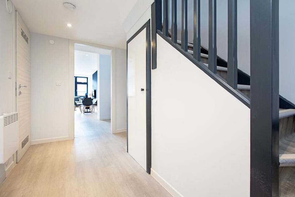Hallway with a staircase leading to the mezzanine bedroom area.