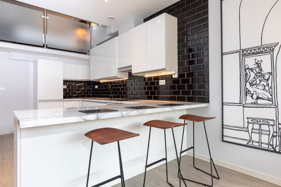 Integrated living, bedroom, and kitchen spaces in an open layout.