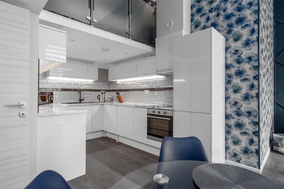 Integrated living, bedroom, and kitchen spaces in an open layout.