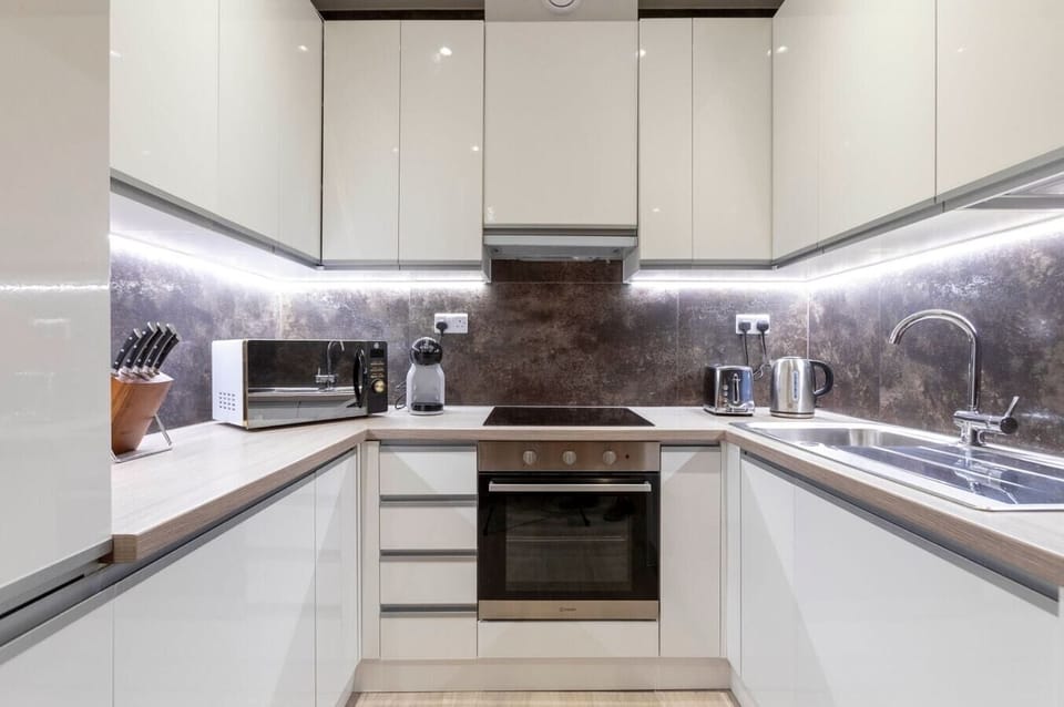 Fully equipped kitchen with all necessary appliances, including a coffee machine and dishwasher.