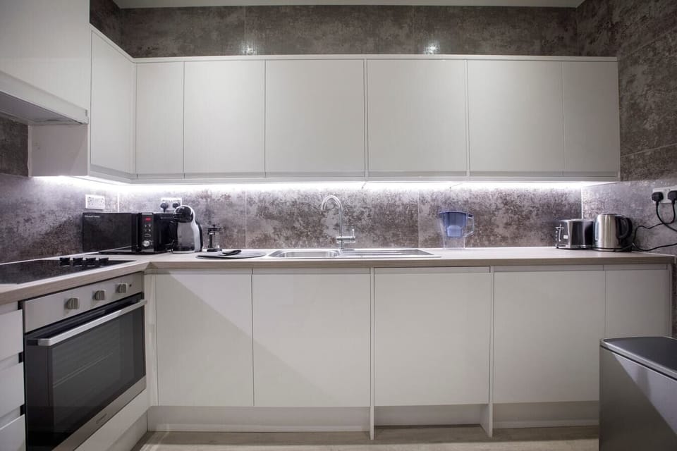 Separate fully equipped kitchen with a dishwasher and coffee maker