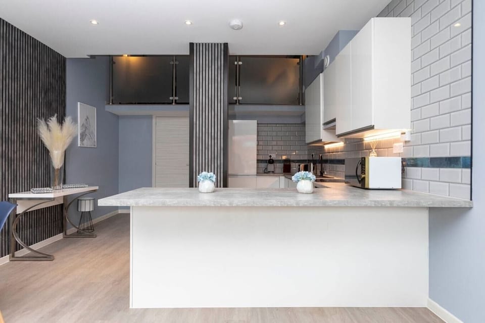 Integrated living, bedroom, and kitchen spaces in an open layout.
