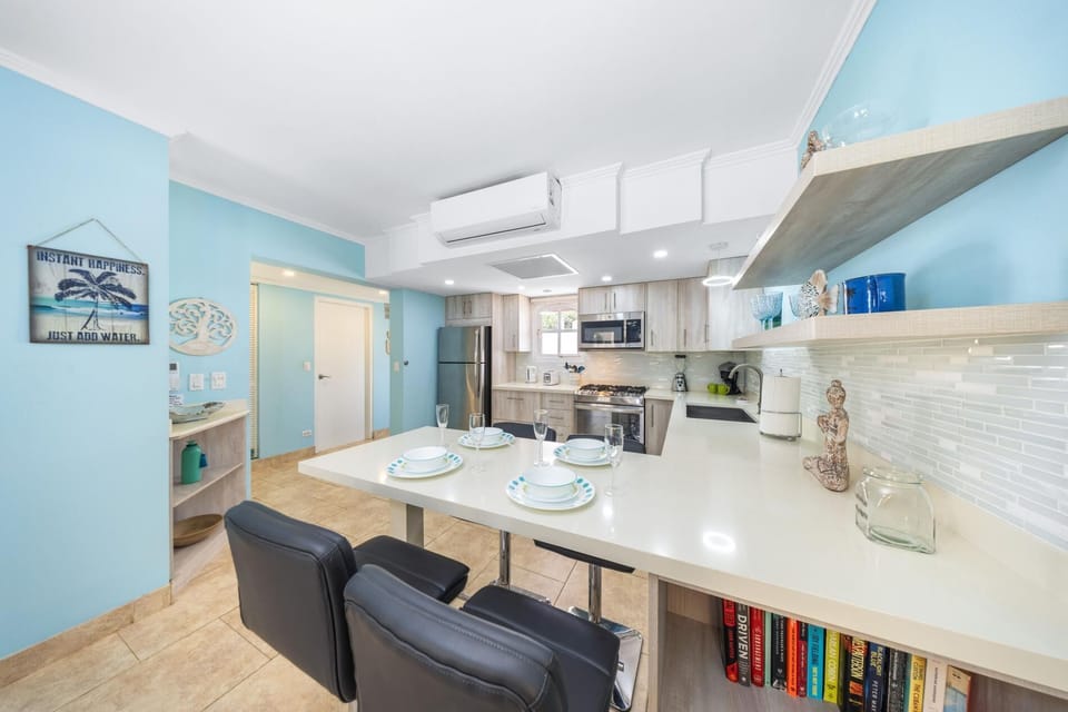 Well-appointed kitchen equipped with a breakfast bar, perfect for casual dining, and a complete set of appliances, including a refrigerator and stove to make mealtime a pleasur