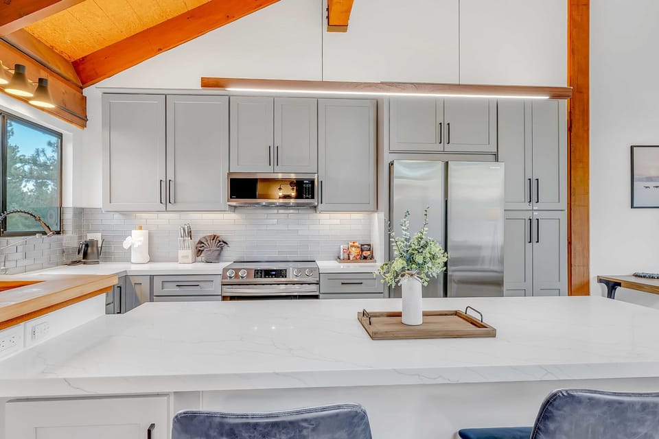 Kitchen: Updated stainless steel appliances, ample cabinet space, drip coffee maker, kitchen bar w/2 bar stools