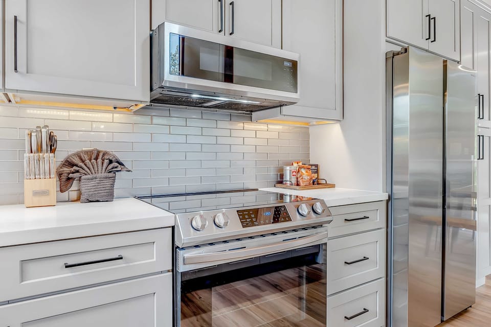 Kitchen: Updated stainless steel appliances, ample cabinet space, drip coffee maker, kitchen bar w/2 bar stools