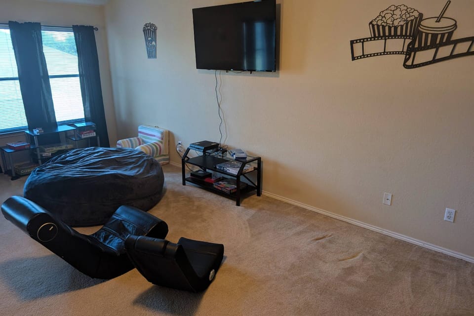 Large game room with Playstation 4 with games, board games, TV and ping pong