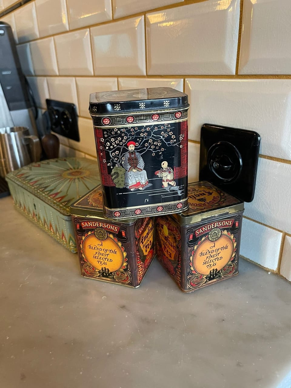 Vintage Art Deco tins and kitchen décor detail in a stylish Brussels apartment.