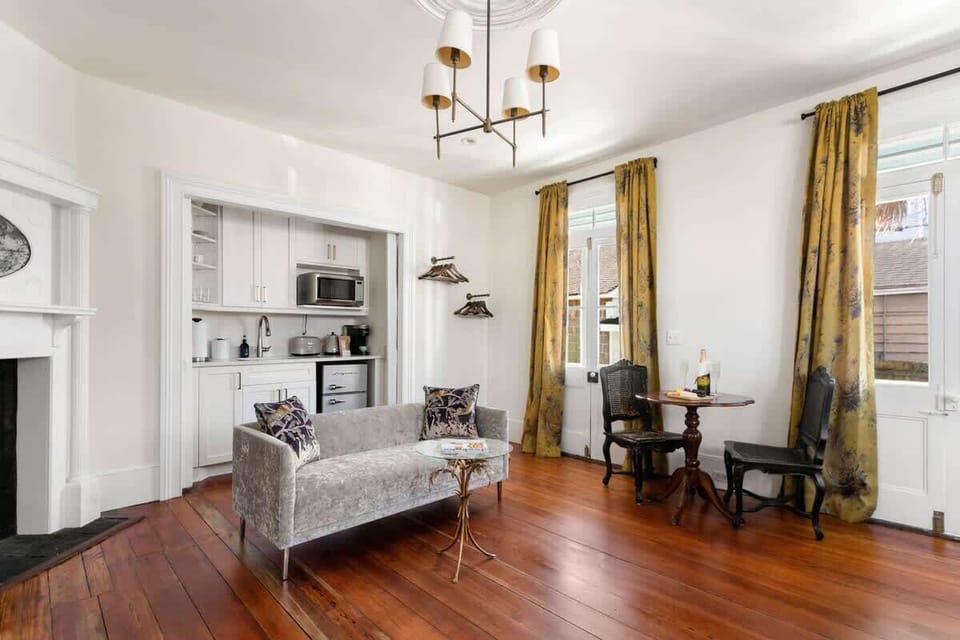 Open space living room with sofa, kitchenette and dining and seating for your group