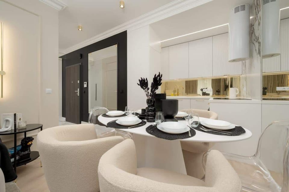 Kitchenette and dining table with tableware.