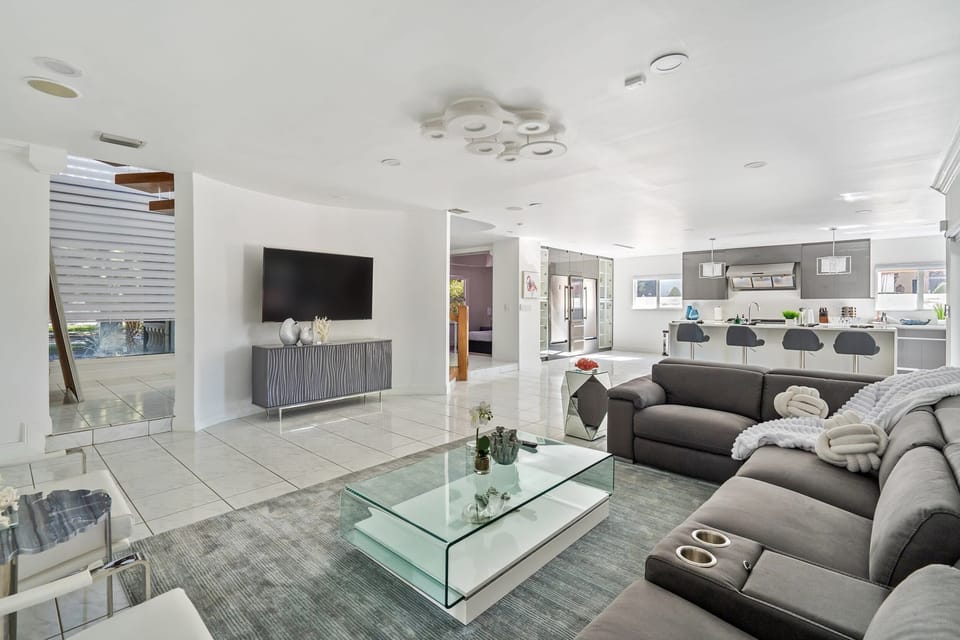 Spacious and open with plenty of seating, this living room is elegant and sophisticated space for you and your companions to sit back, catch up, and watch TV.