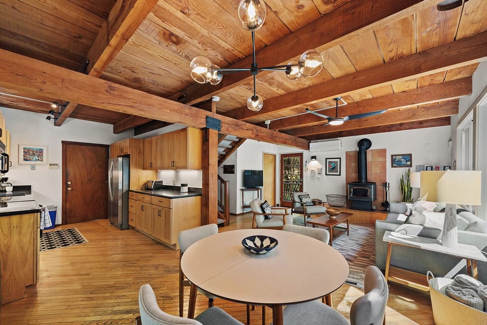 The expandable dining table is open to the kitchen and living room.