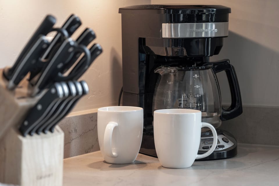 - Coffee maker with mugs ready for your morning brew   - Essential kitchen setup for fresh coffee anytime   - Start the day energized with mountain inspired views
