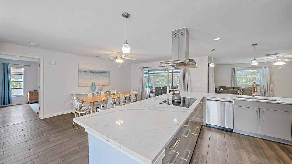 Large kitchen island overlooking dining area. Perfect for family or friend gatherings and meal preparation.