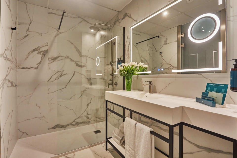 Shower, designer toiletries, hair dryer, towels