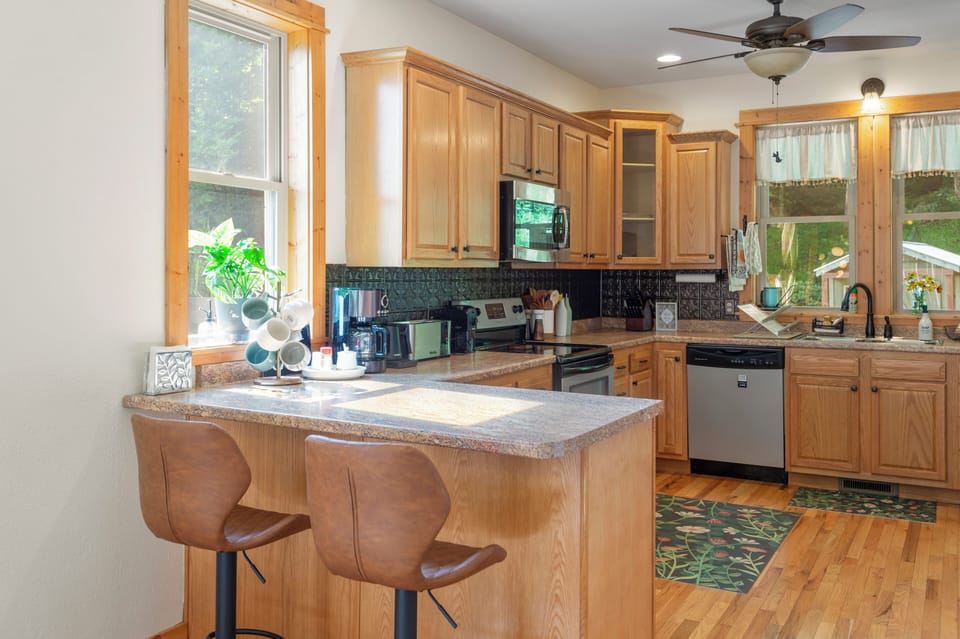 The roomy kitchen is fully stocked with appliances, cookware, and utensils