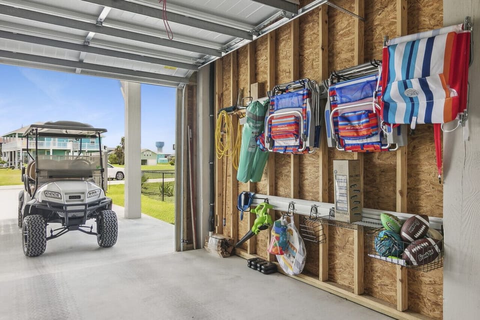 Five beach chairs and golf cart ready for your seaside adventures