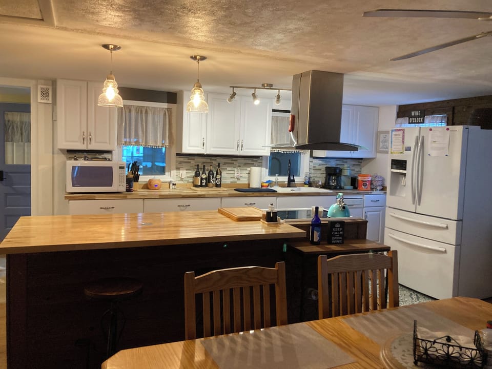 Well stocked kitchen with full size fridge with ice maker and water dispenser