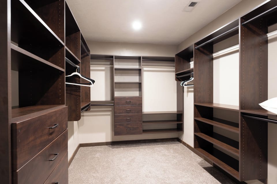 - Expansive walk-in closet with built-in shelving  
- Ample space for hanging clothes and storage  
- Carpeted flooring adds comfort and warmth