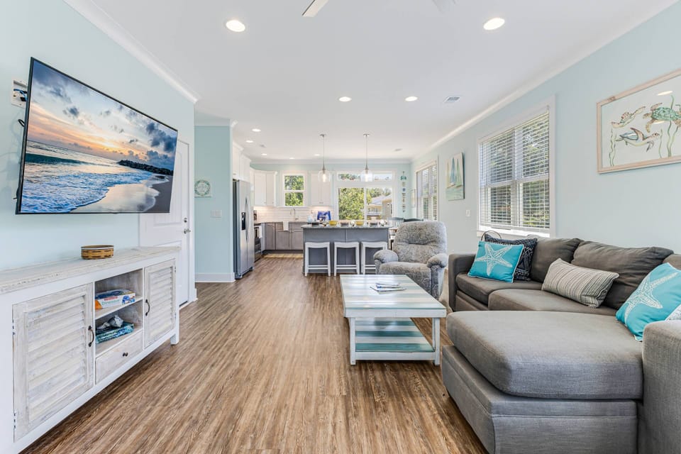 The living area is open and connected to the kitchen, creating a seamless and inviting space for relaxation and dining.