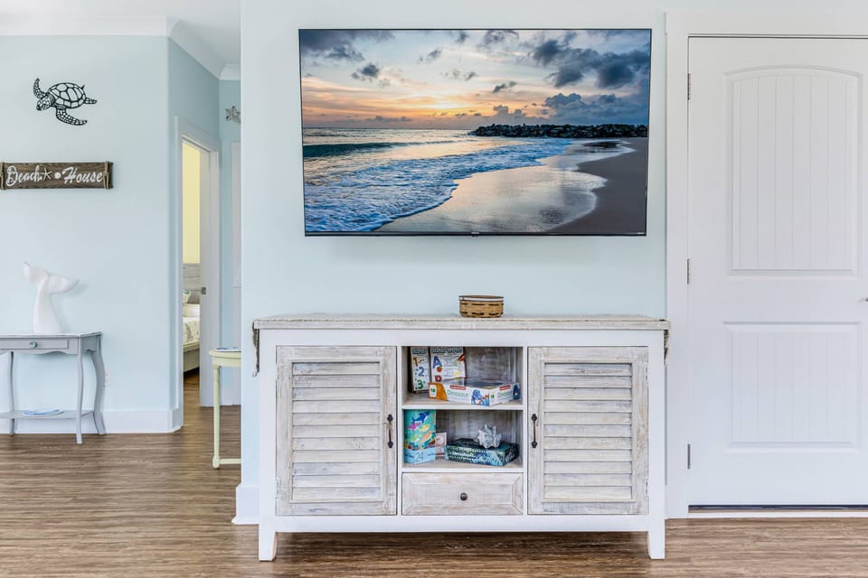 Enjoy the flat-screen Roku TV, and below it, you’ll find a selection of board games, perfect for some family fun or a relaxing game night.