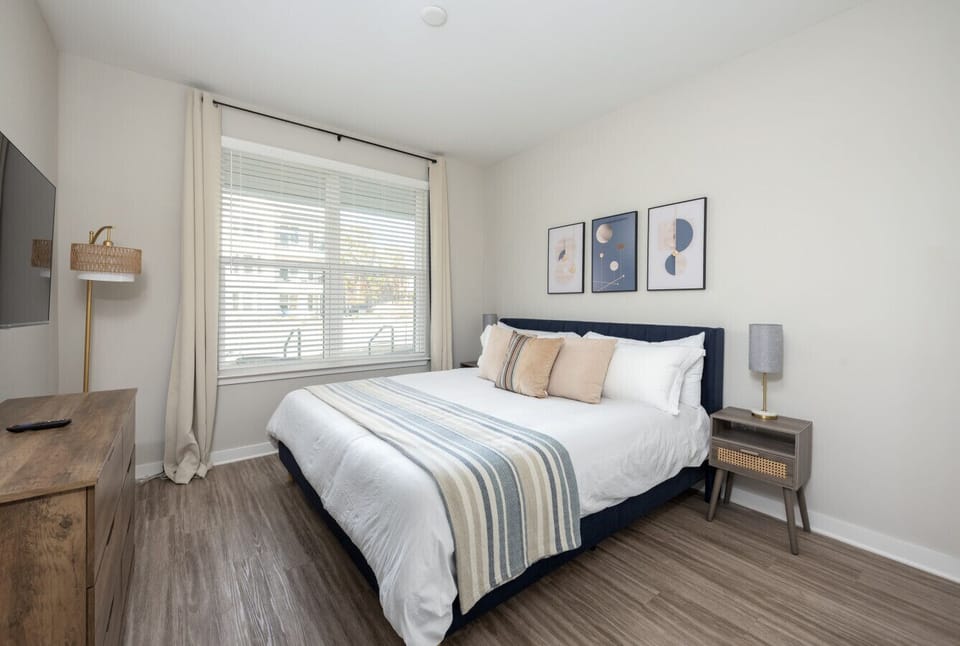 Second king bedroom with dresser, walk-in closet and smart TV