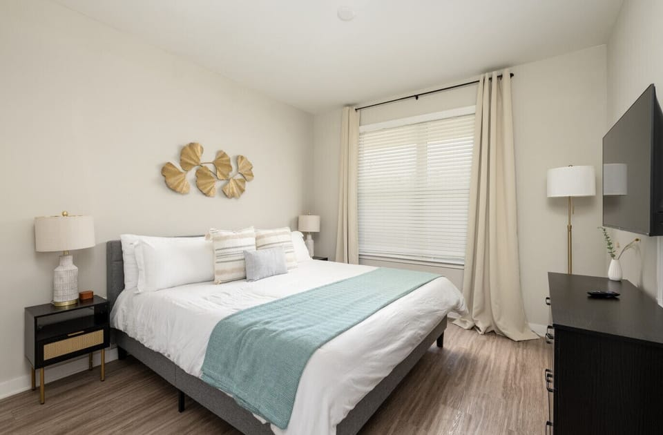 Second king bedroom with dresser, walk-in closet and smart TV