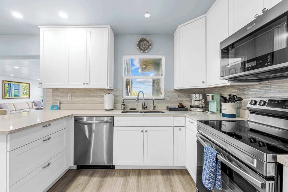 Modern kitchen with stainless steel appliances and white cabinetry