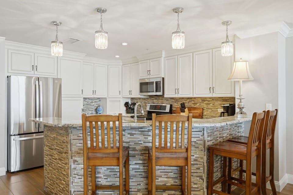Picture yourself preparing meals in this bright kitchen with gleaming stainless appliances, ample counter space, and a stylish island where your group can gather for casual conversation.