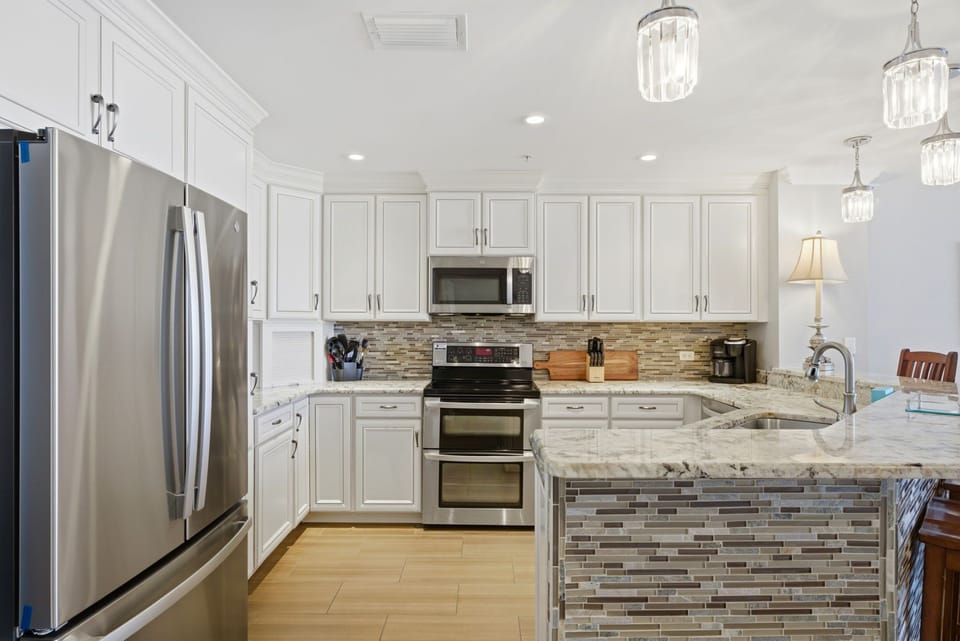 Your gourmet kitchen awaits with granite countertops, stainless steel appliances, and a spacious island—perfect for whipping up vacation meals and morning coffee together.