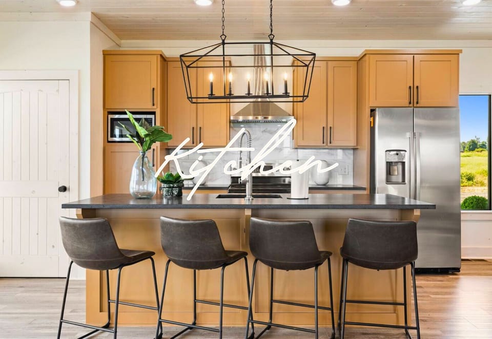 Meet the kitchen of your dreams! It has a big island, stainless steel appliances, and plenty of room to whip up your favorite meals.