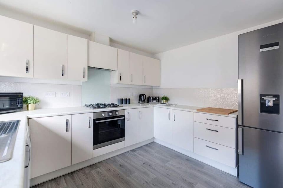 "Cook in style in our beautiful modern kitchen—fully equipped and thoughtfully designed for a sleek, effortless culinary experience."