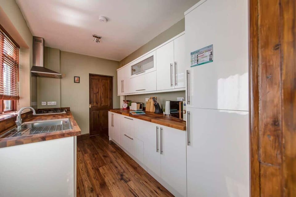 "Cook and dine in this fully equipped, spotless kitchen—featuring modern appliances, ample counter space, and everything you need to prepare your favorite meals."