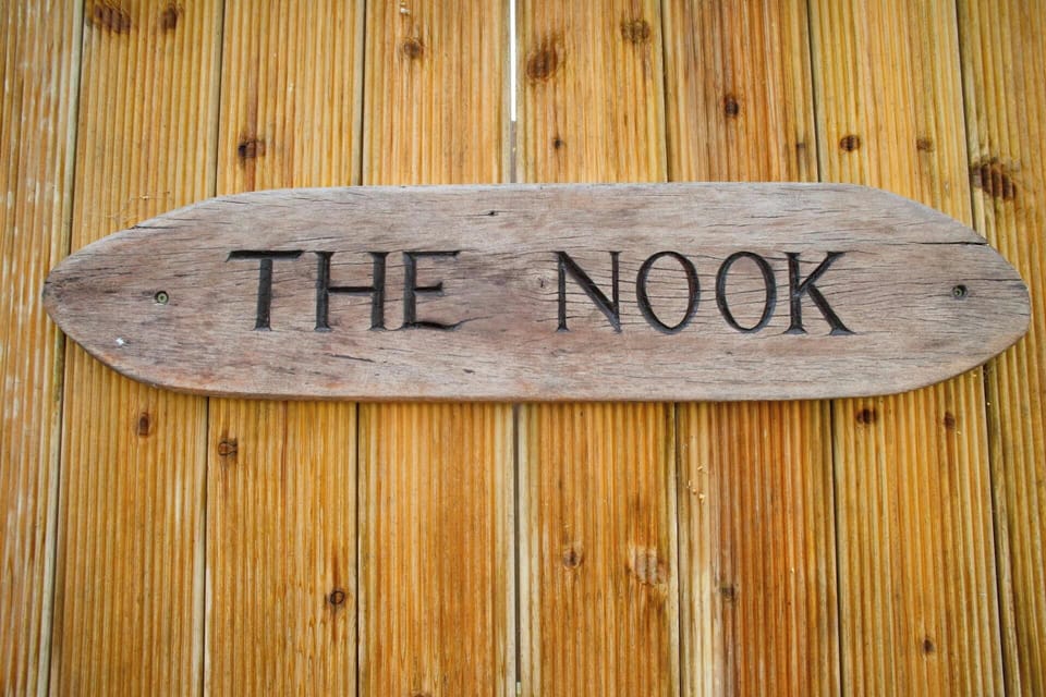 Wooden sign outside for The Nook