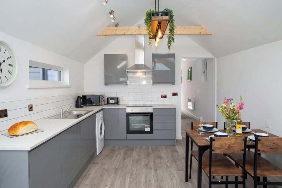 Kitchen area with microwave, electric hob and oven