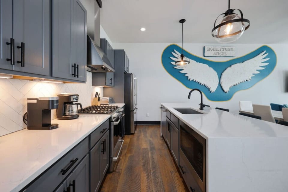 Modern kitchen with stainless steel appliances and island.