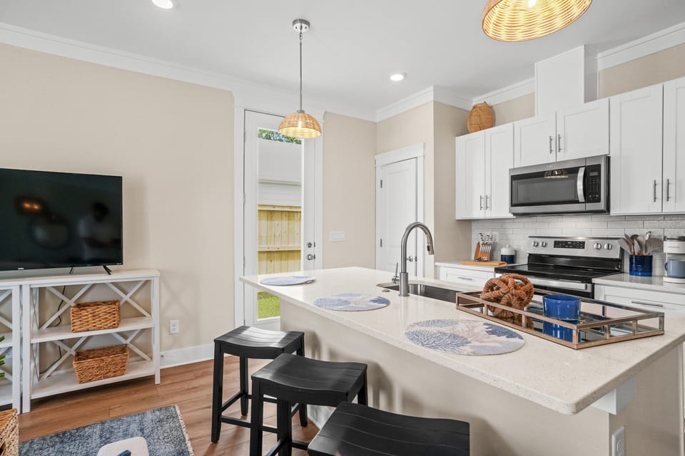 Your bright, modern kitchen features white cabinets, granite counters, and a breakfast bar where you can enjoy morning coffee or casual meals.