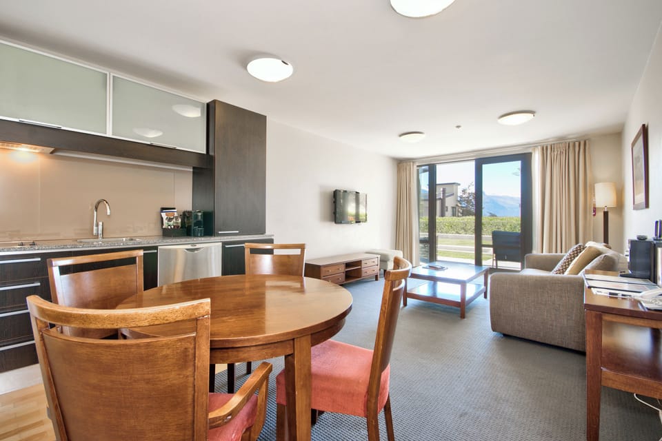 Deluxe Apartment, Courtyard View | Living area | TV
