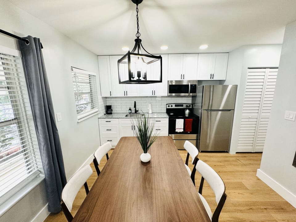 Gather around this cozy dining table designed for four, where shared meals turn into cherished moments. The simple yet stylish setup invites connection, adorned with comfortable seating and a tabletop ready for laughter and conversations