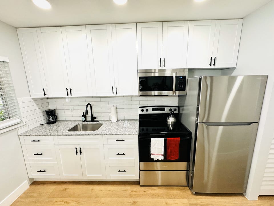 Welcome to your modern kitchen with sleek countertops, stainless-steel appliances, and ample storage. Natural light enhances the warm ambiance, creating a versatile and inviting space for all your culinary endeavors.