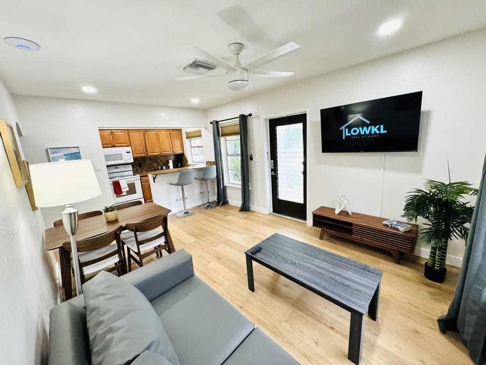 Welcome to your comfortable living room retreat, featuring a plush couch. The inviting ambiance is complemented by a practical coffee table, offering a convenient surface for your essentials. A smart TV provides endless entertainment possibilities.