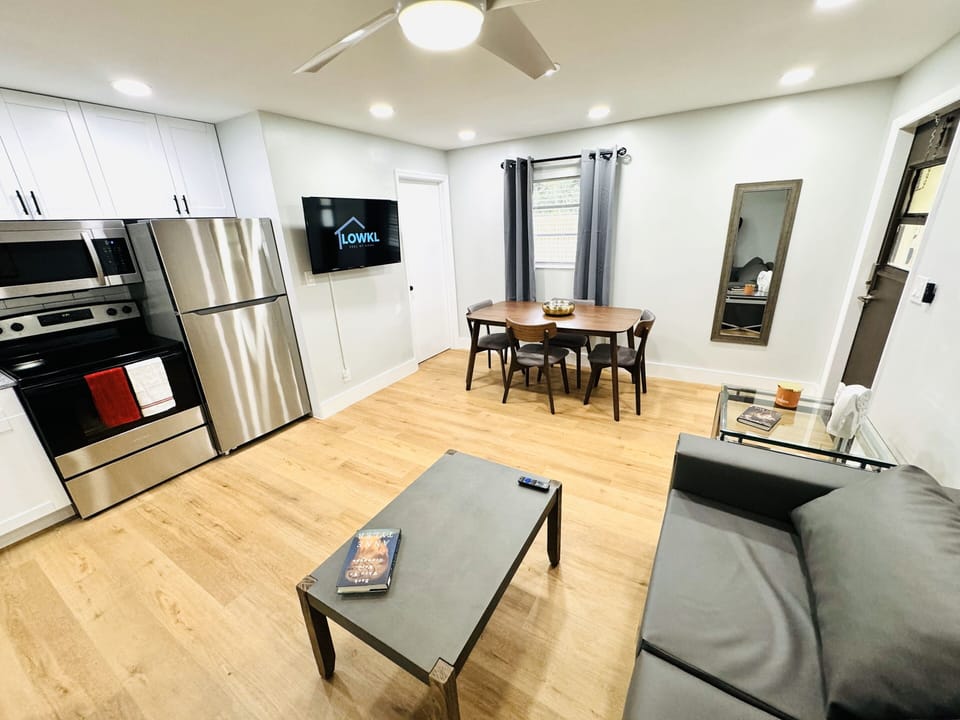 Welcome to your comfortable living room retreat, featuring a plush couch. The inviting ambiance is complemented by a practical coffee table, offering a convenient surface for your essentials. A smart TV provides endless entertainment possibilities.