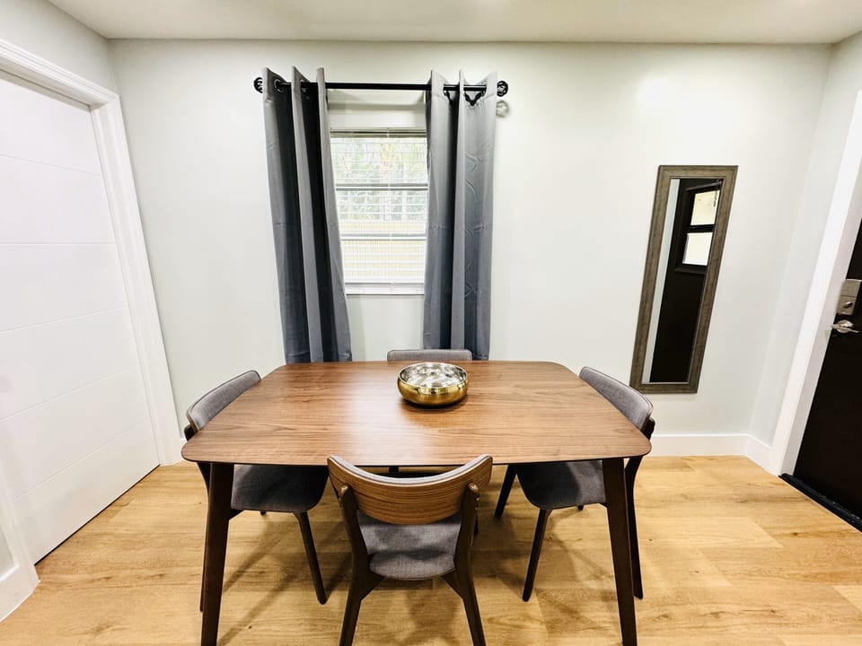 Gather around this cozy dining table designed for four, where shared meals turn into cherished moments. The simple yet stylish setup invites connection, adorned with comfortable seating and a tabletop ready for laughter and conversations